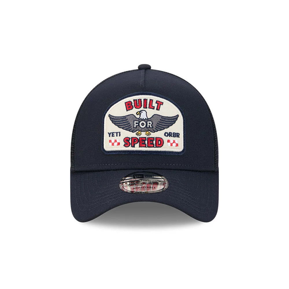 Red Bull Racing Yeti X Red Bull Racing Black New Era 9FORTY A-Frame Trucker Adjustable Cap, front view showing a Built for Speed embroidered patch with an eagle on the front panel, black curved visor, and 9FORTY size sticker placed centrally.