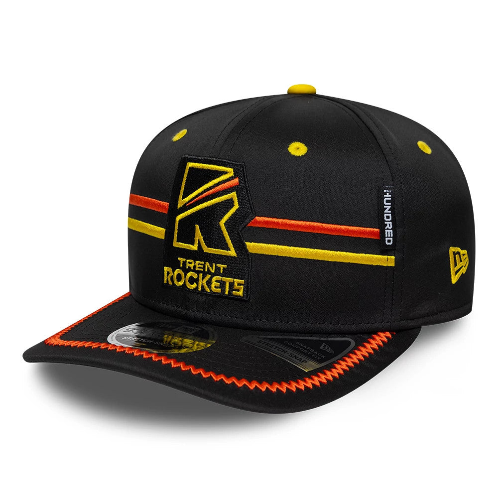 Trent Rockets The Hundred 2026 Black New Era 9SEVENTY Stretch Snap Adjustable Cap, three-quarter view showing the embroidered team logo in yellow and orange on the front panel, with orange accent stitching on the black visor and yellow top button.