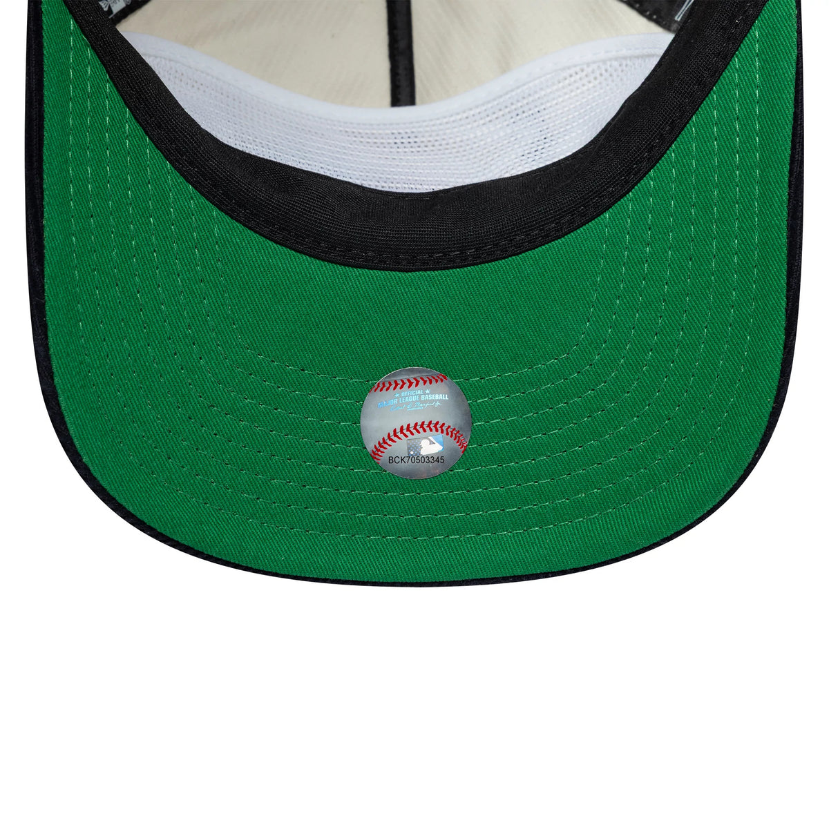 New York Yankees MLB Retro Dynasty Cream & Navy New Era 19TWENTY Adjustable Cap, inside view showing a green undervisor with white stitching, a baseball-themed sticker at the centre, and white mesh panels near the sweatband.