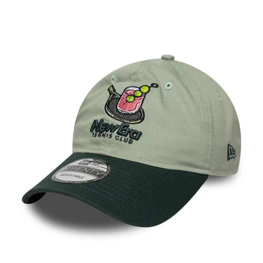 New Era Tennis Club Pastel Green 9TWENTY Adjustable Cap, front view showing a playful embroidered cocktail logo with tennis ball details on the front panel, a contrasting dark green visor, and a 9TWENTY size sticker on the visor.