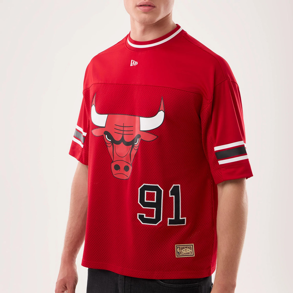 New Era Chicago Bulls NBA Hardwood Classic Mesh Oversized Red T-Shirt, front view on a model displaying the large Bull graphic centred on the chest, embroidered white New Era logo below the collar.
