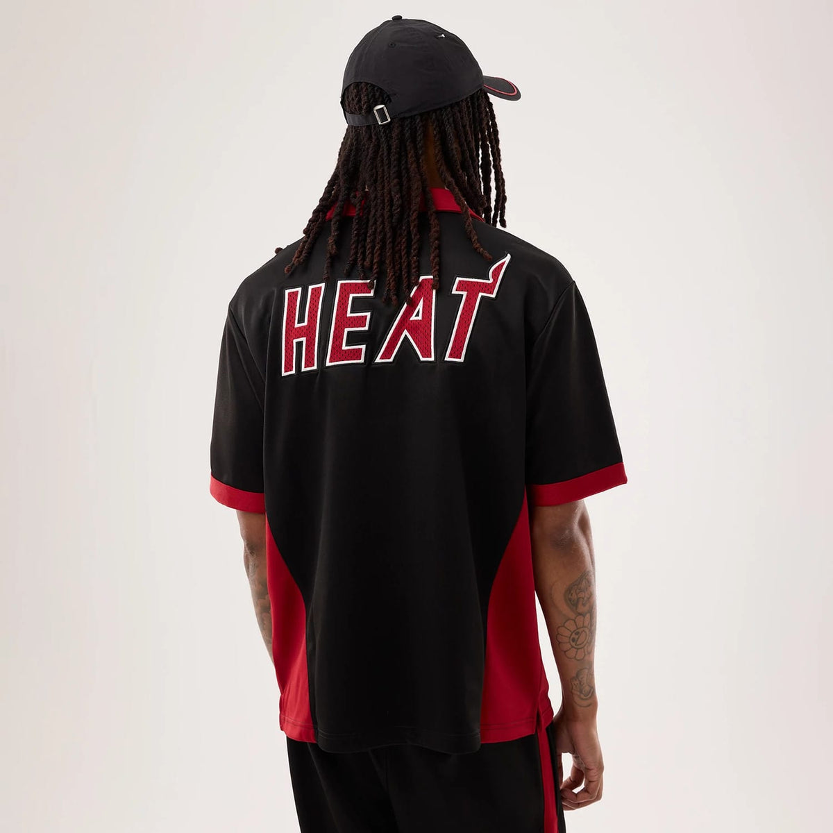 The model is wearing this NBA Hardwood Classic Revere Miami Heat Short Sleeve Shirt in black. 2