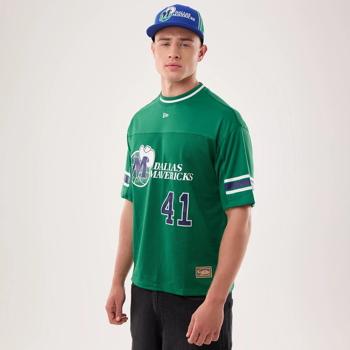 New Era Dallas Mavericks NBA Hardwood Classic Mesh Oversized Green T-Shirt, front view on a model, displaying the large Mavericks logo and lettering across the chest, number 41 below, and embroidered New Era logo centred on the green mesh material.