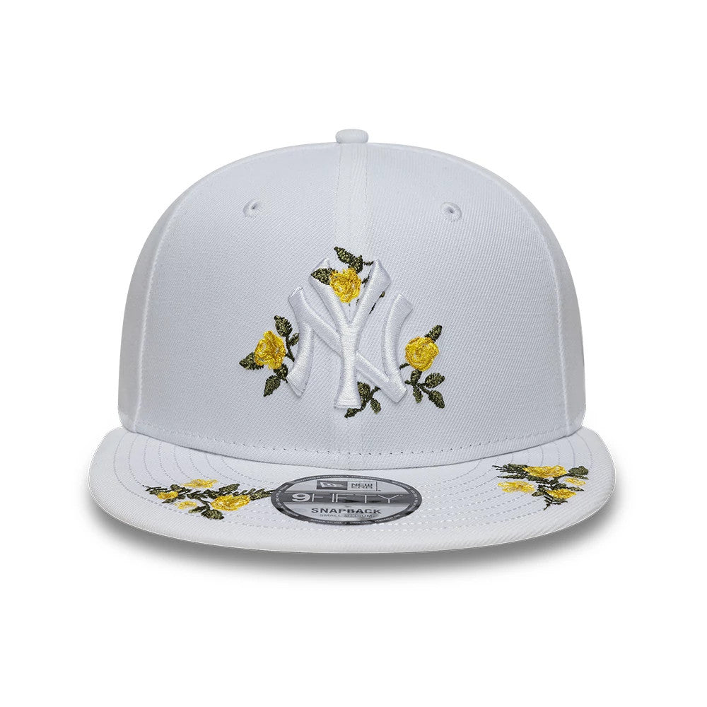 New York Yankees MLB Floral White New Era 9FIFTY Snapback Adjustable Cap, front view showing the raised white NY logo with yellow floral embroidery on the front panel, white flat visor and a 9FIFTY size sticker on the centre.