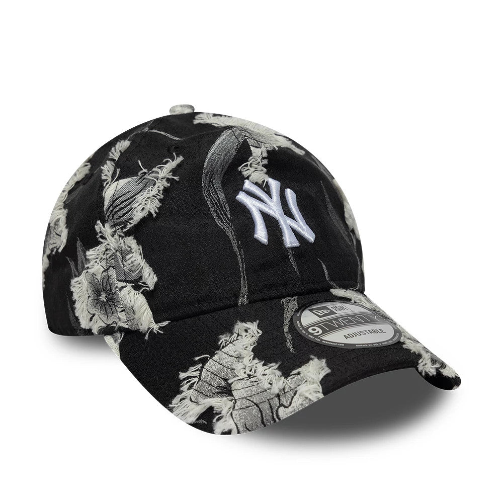 New York Yankees MLB Frayed Black New Era 9TWENTY Adjustable Cap, front view showing a white embroidered NY logo on the black frayed fabric, with a floral pattern on the crown and visor, plus the 9TWENTY size sticker on the curved visor.