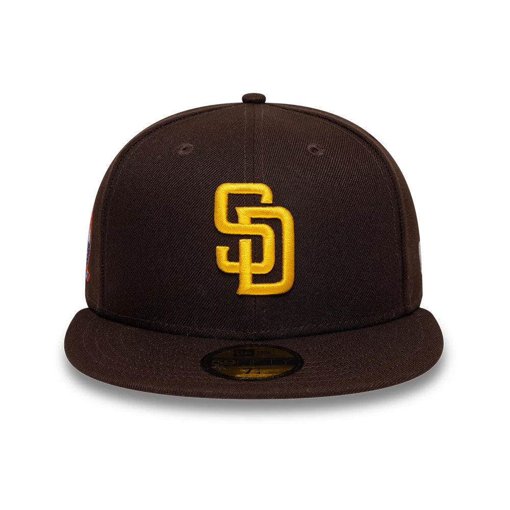 San Diego Padres MLB Cooperstown Dark Brown New Era 59FIFTY Fitted Cap, front view showing the raised yellow embroidered SD logo on the structured dark brown crown, with a matching dark brown visor and a gold 59FIFTY size sticker on the visor.