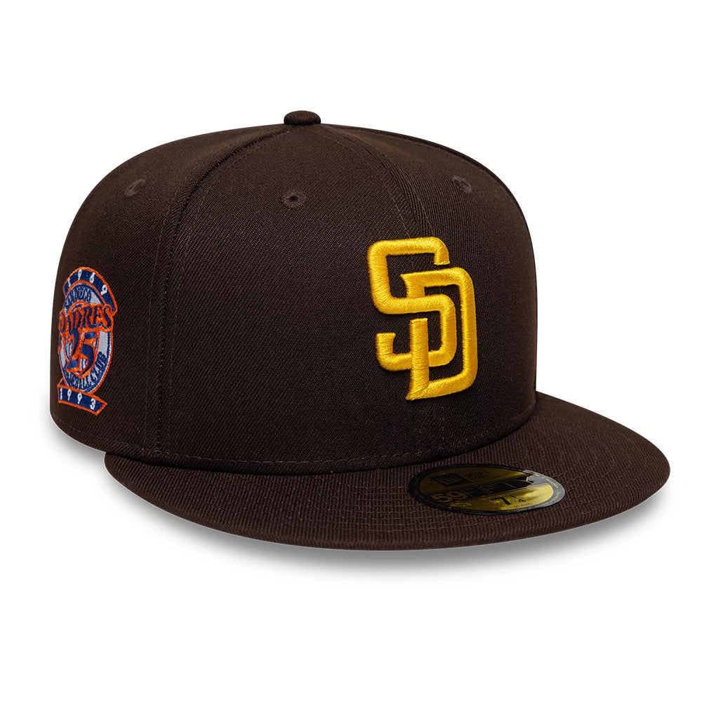 San Diego Padres MLB Cooperstown Dark Brown New Era 59FIFTY Fitted Cap, three-quarter view showing a raised yellow embroidered SD logo on the front panels, a commemorative Padres patch on the right side.