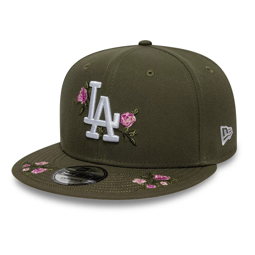 LA Dodgers MLB Floral Green New Era 9FIFTY Snapback Adjustable Cap, three-quarter view showing a white raised embroidered LA logo on the front panel with pink floral embroidery around it.