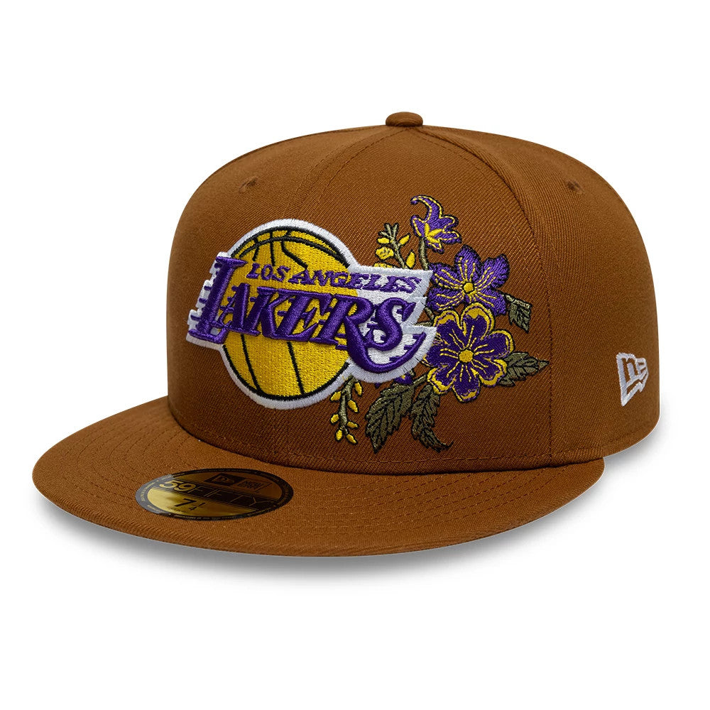 LA Lakers NBA Floral Brown New Era 59FIFTY Fitted Cap, three-quarter view showing the embroidered Lakers logo with a basketball and purple floral design on the front panel, brown flat visor, and the New Era flag logo on the left side.