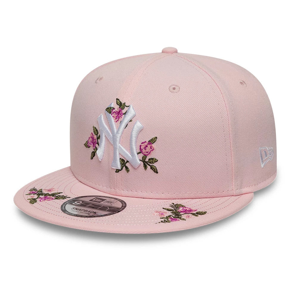 New York Yankees MLB Floral Pastel Pink New Era 9FIFTY Snapback Adjustable Cap, front view showing raised white NY logo with pink floral embroidery on the front panel and visor, alongside a 9FIFTY size sticker.
