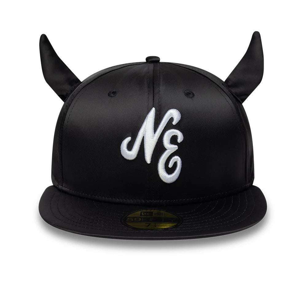 New Era Satin Horn Black 59FIFTY Fitted Cap, front view showing large white embroidered NE initials on the black satin crown, distinctive pointed horns on either side, and gold 59FIFTY size sticker on the flat black visor.