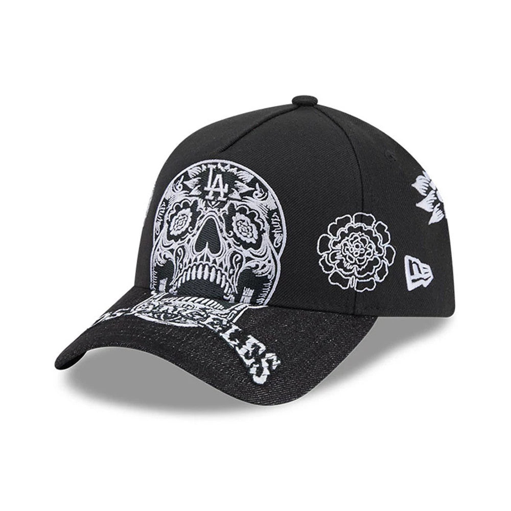 LA Dodgers MLB Day Of The Dead Black New Era 9FORTY A-Frame Adjustable Cap, three-quarter view showing the intricately embroidered white skull motif on the front panels, white floral designs on the left side, and Los Angeles text on the black visor.