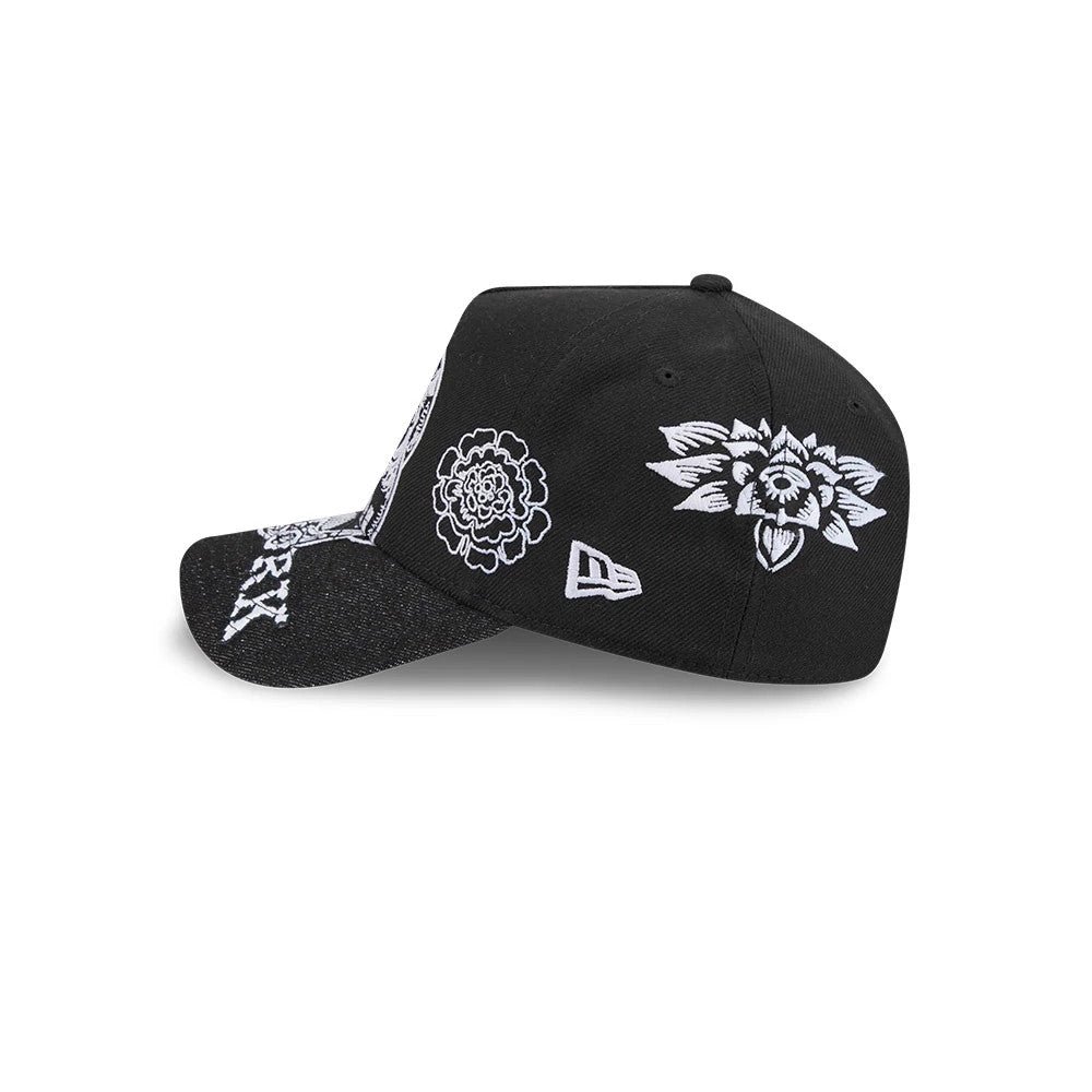 New York Yankees MLB Day Of The Dead Black New Era 9FORTY A-Frame Adjustable Cap, side view showing intricate white floral embroidery on the black crown, a curved black visor with white accents, and the New Era flag logo on the left side.