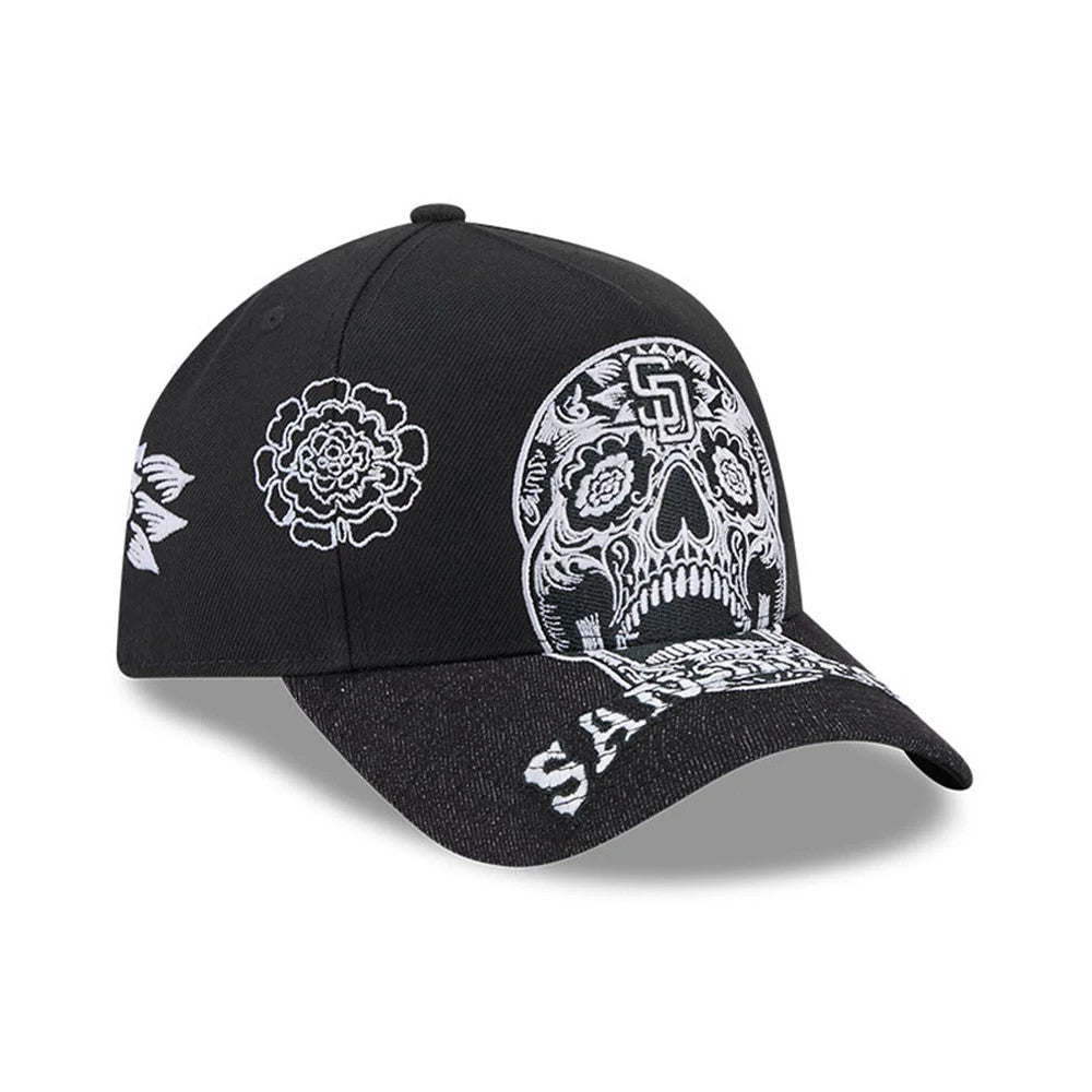 San Diego Padres MLB Day Of The Dead Black New Era 9FORTY A-Frame Adjustable Cap, three-quarter view showing the white sugar skull design with intricate details on the front panel, a black curved visor with SD embroidery.