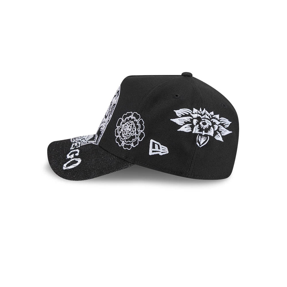San Diego Padres MLB Day Of The Dead Black New Era 9FORTY A-Frame Adjustable Cap, side view showing a white New Era flag logo on the left side, detailed floral embroidery on the black crown, and a slightly curved, black textured visor.
