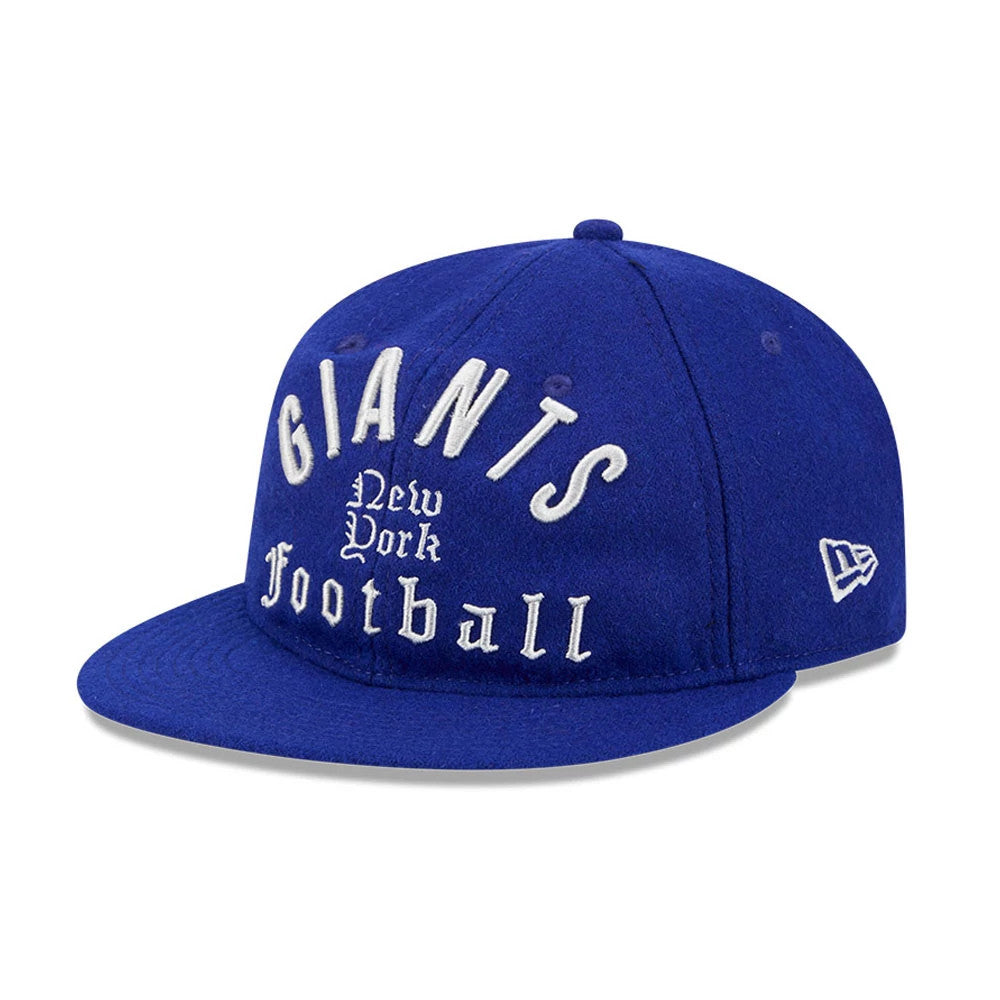 Giants NFL Historic Arch Dark Blue Retro Crown New Era 59FIFTY Fitted Cap, three-quarter view showing raised white embroidered Giants lettering on the front panel, a blue flat visor, and the New Era flag logo on the left side.