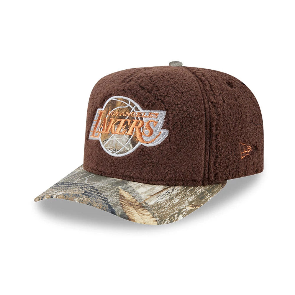 LA Lakers NBA Hardwood Classic Brown New Era 59FIFTY A-Frame Fitted Cap, three-quarter view showing the raised orange Lakers logo on the front panel, a camo-patterned flat visor, and the New Era flag logo embroidered on the left side.