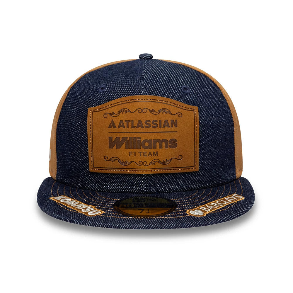 Williams Team Austin Race Special Navy New Era 59FIFTY Fitted Cap, front view showing the raised brown leather patch with Atlassian Williams F1 Team logo on the crown, dark navy denim fabric, and a gold 59FIFTY size sticker on the visor.
