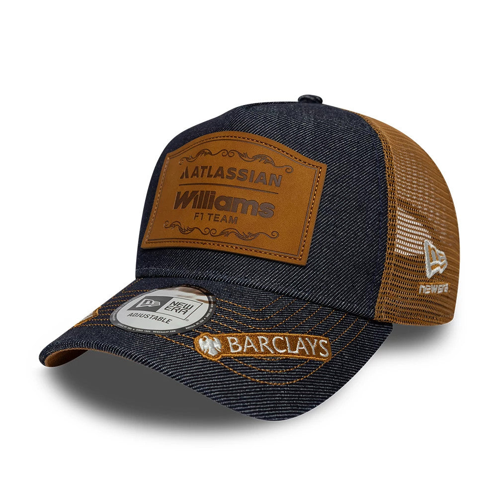 Williams Carlos Sainz Austin Race Special Navy New Era 9FORTY E-Frame Trucker Adjustable Cap, three-quarter view showing a brown leather-look patch with Williams F1 Team logo on the front panel, Barclays logo in white on the curved visor.