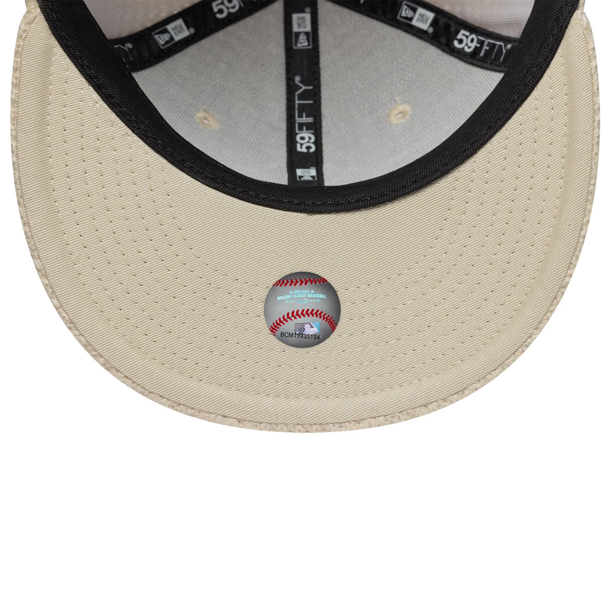 New York Yankees MLB Knitted Light Beige New Era 59FIFTY Fitted Cap, inside view showing the black New Era branded taping, the matching beige undervisor, and a white baseball design sticker placed centrally on the visor.