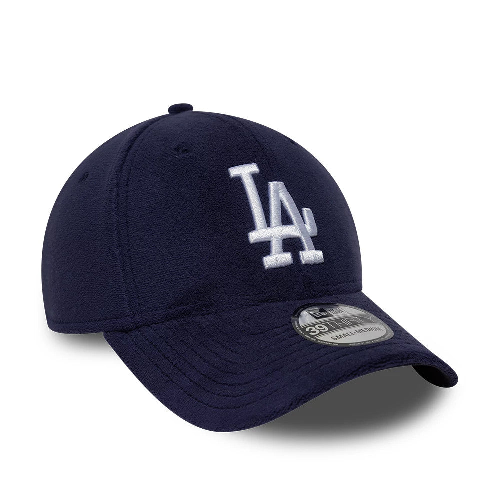 LA Dodgers MLB Fleece Navy New Era 39THIRTY Stretch Fit Cap, three-quarter view showing the raised white LA logo embroidered on the front panel, a curved visor with the 39THIRTY size sticker, and a soft navy fleece crown.