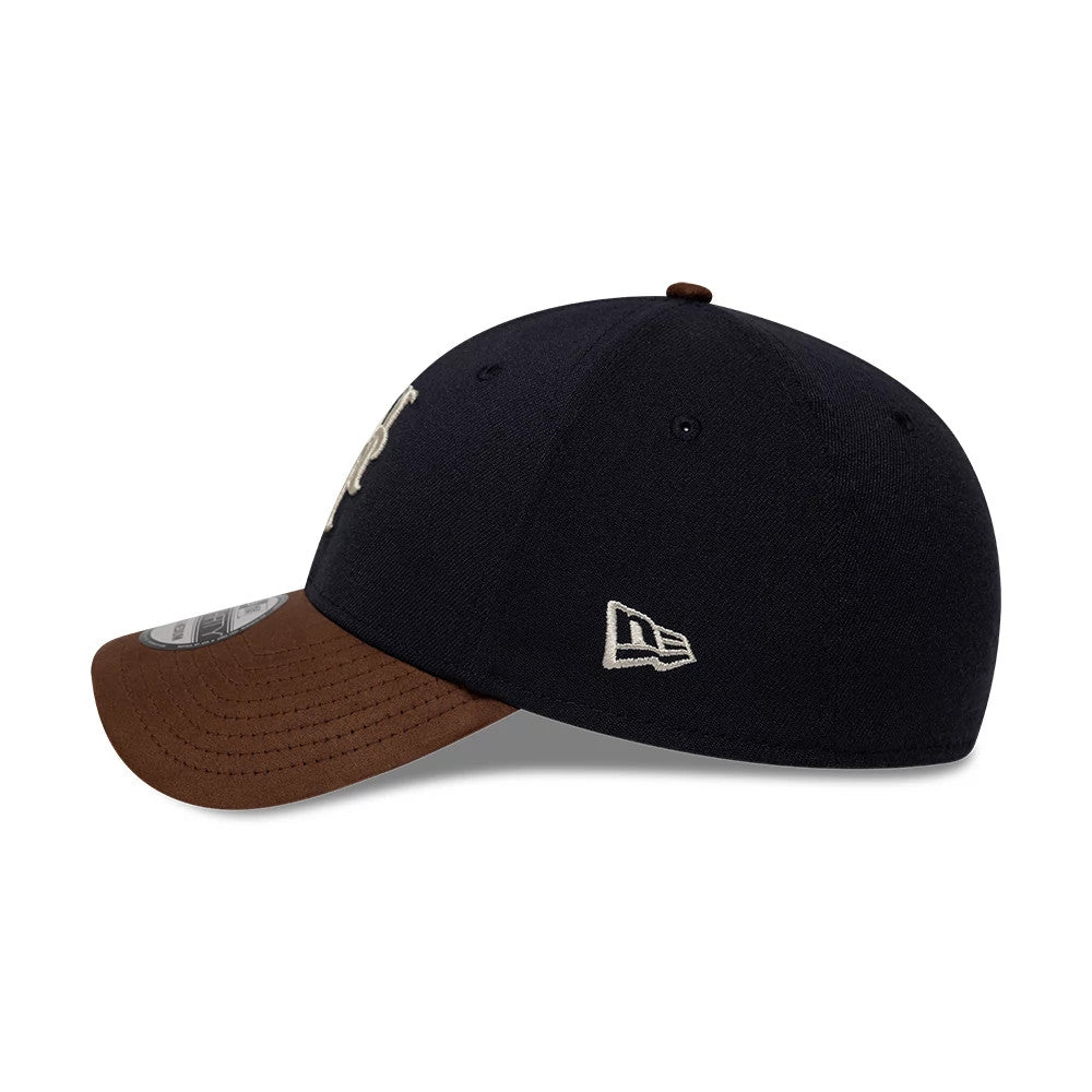 New York Mets MLB Faux Suede Navy & Brown New Era 39THIRTY Stretch Fit Cap, side view showing the white embroidered New Era flag logo on the navy panel, curved brown faux suede visor, and black eyelets on the structured crown.