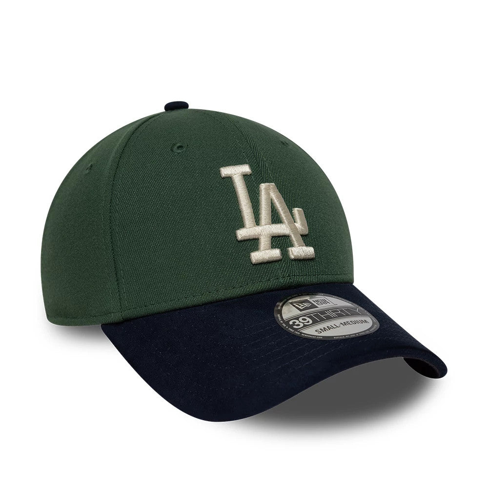 LA Dodgers MLB Faux Suede Dark Green & Navy New Era 39THIRTY Stretch Fit Cap, three-quarter view showing the raised white LA logo embroidered on the structured dark green crown, contrasted with a curved navy visor featuring a 39THIRTY size sticker.