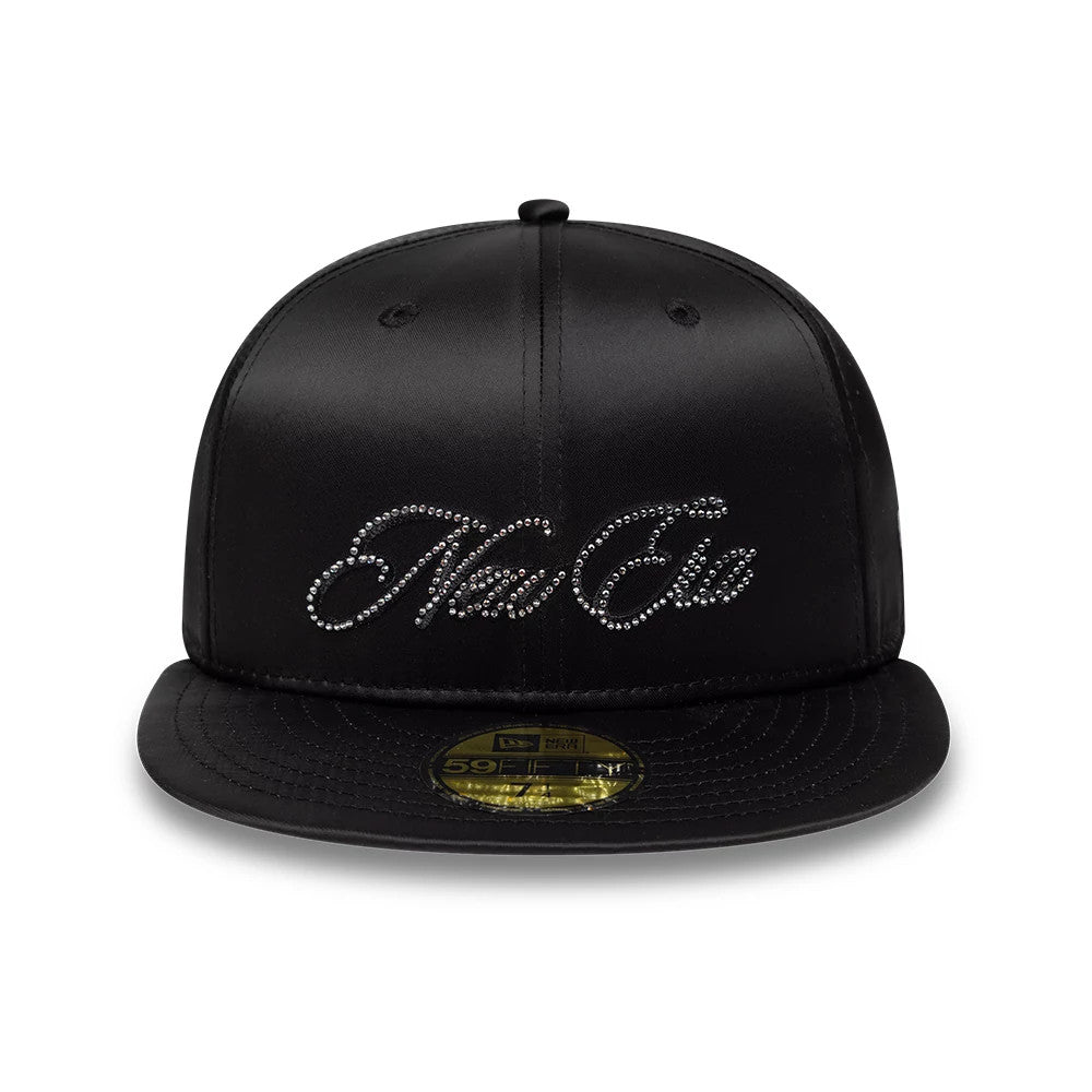 New Era Satin Diamante Black 59FIFTY Fitted Cap, front view showing the sparkling diamante New Era script logo across the centre of the black satin crown, with a flat black visor and a gold 59FIFTY size sticker on the visor.