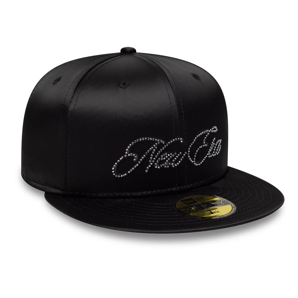 New Era Satin Diamante Black 59FIFTY Fitted Cap, three-quarter view showing the sparkling diamante-embellished script logo on the front panel, satin black fabric, and a gold 59FIFTY size sticker on the flat black visor.