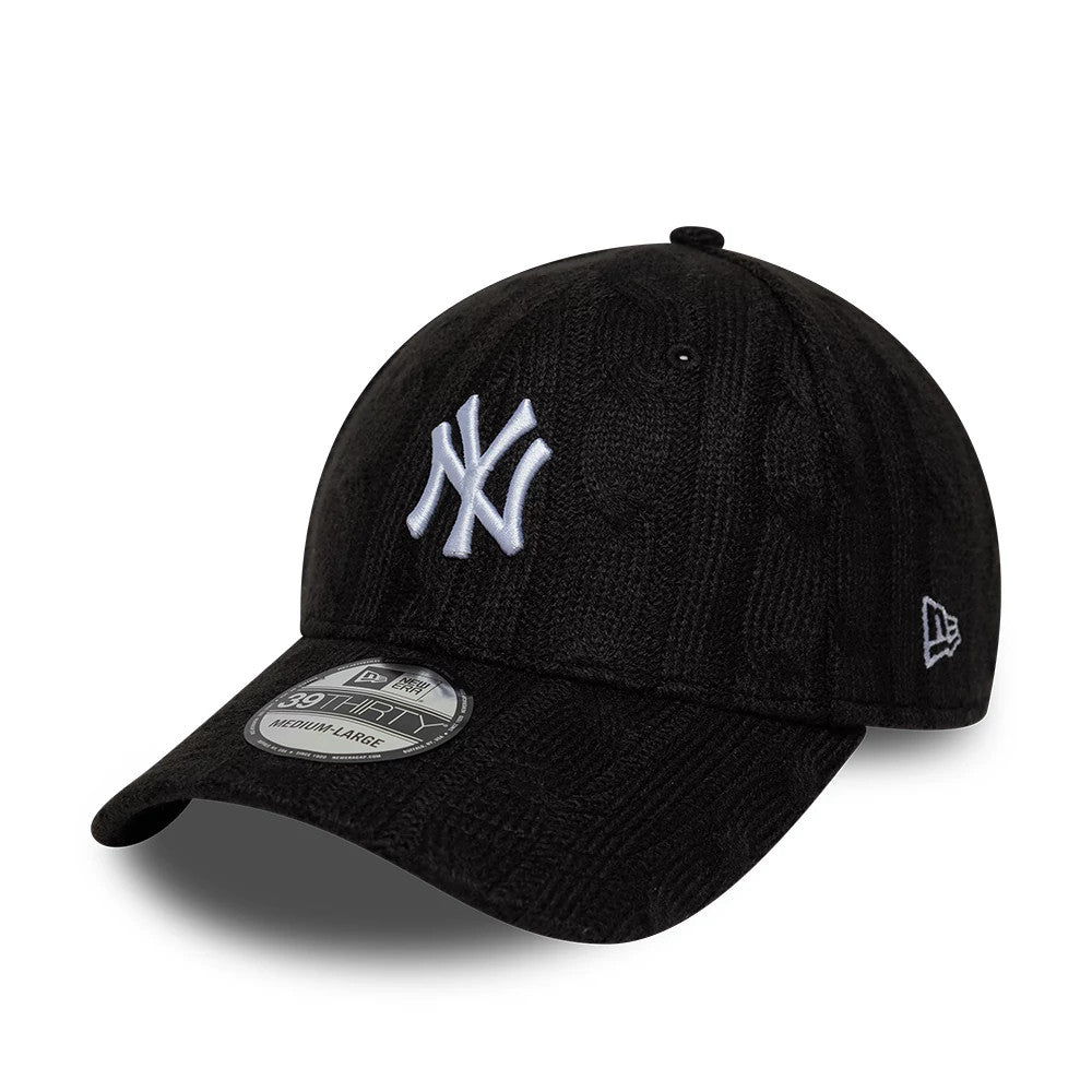 New York Yankees MLB Knitted Black New Era 39THIRTY Stretch Fit Cap, three-quarter view showing the white raised embroidered NY logo on the front panel, with the New Era flag logo on the left side and a 39THIRTY size sticker on the black visor.