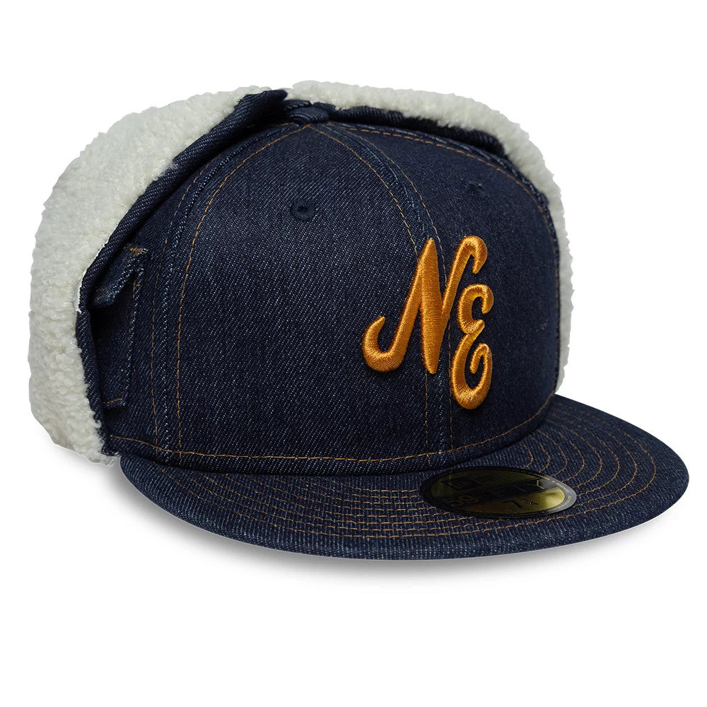 New Era Denim Navy Dogear 59FIFTY Fitted Cap, three-quarter view showing raised gold NE embroidery on the front panel, denim fabric with stitched detailing, and plush white dogear flaps for warmth.