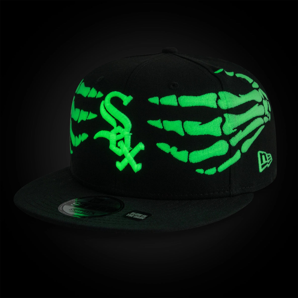 White Sox MLB Halloween Glow In The Dark Hands Black New Era 9FIFTY Snapback Adjustable Cap, front view showing a green glow-in-the-dark skeletal hands graphic across black panels, neon green embroidered White Sox logo on the front.