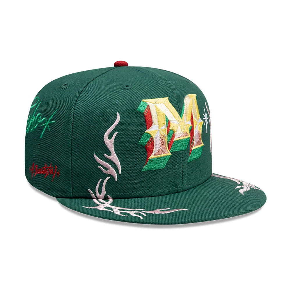New Era Mexico Rotulos Green 59FIFTY Fitted Cap, three-quarter view showing a large embroidered gold and red M on the front panel, intricate white flame patterns on the green visor, and side on the structured crown.