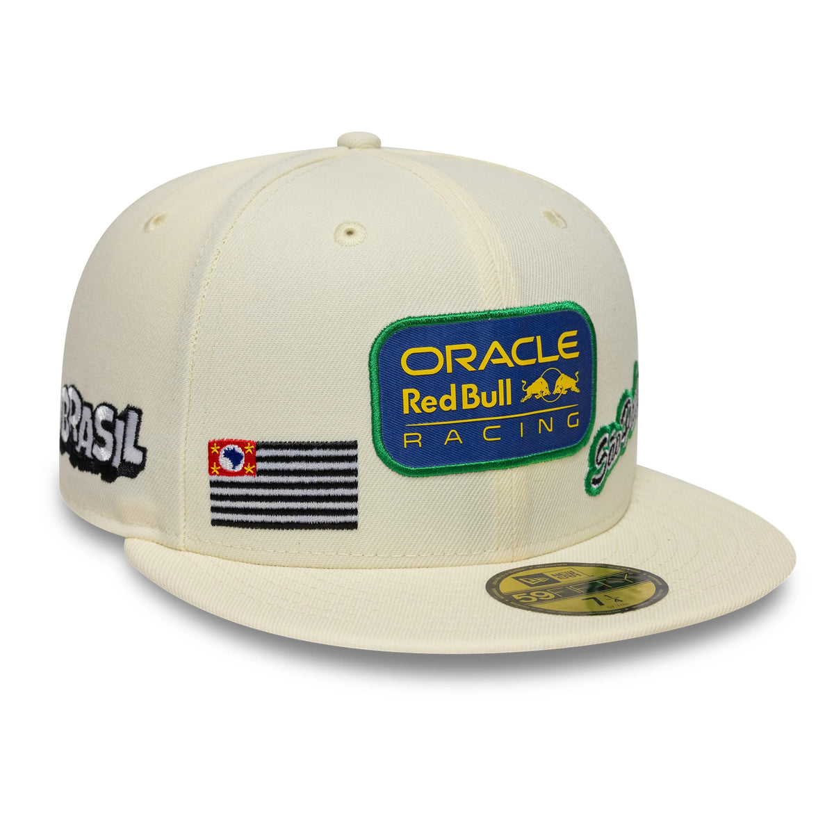 Red Bull Racing Brazil Race Special Cream New Era 59FIFTY Fitted Cap, three-quarter view showing a blue, yellow, and green Oracle Red Bull Racing patch on the front panel, a black-striped flag and São Paulo patch on the side.