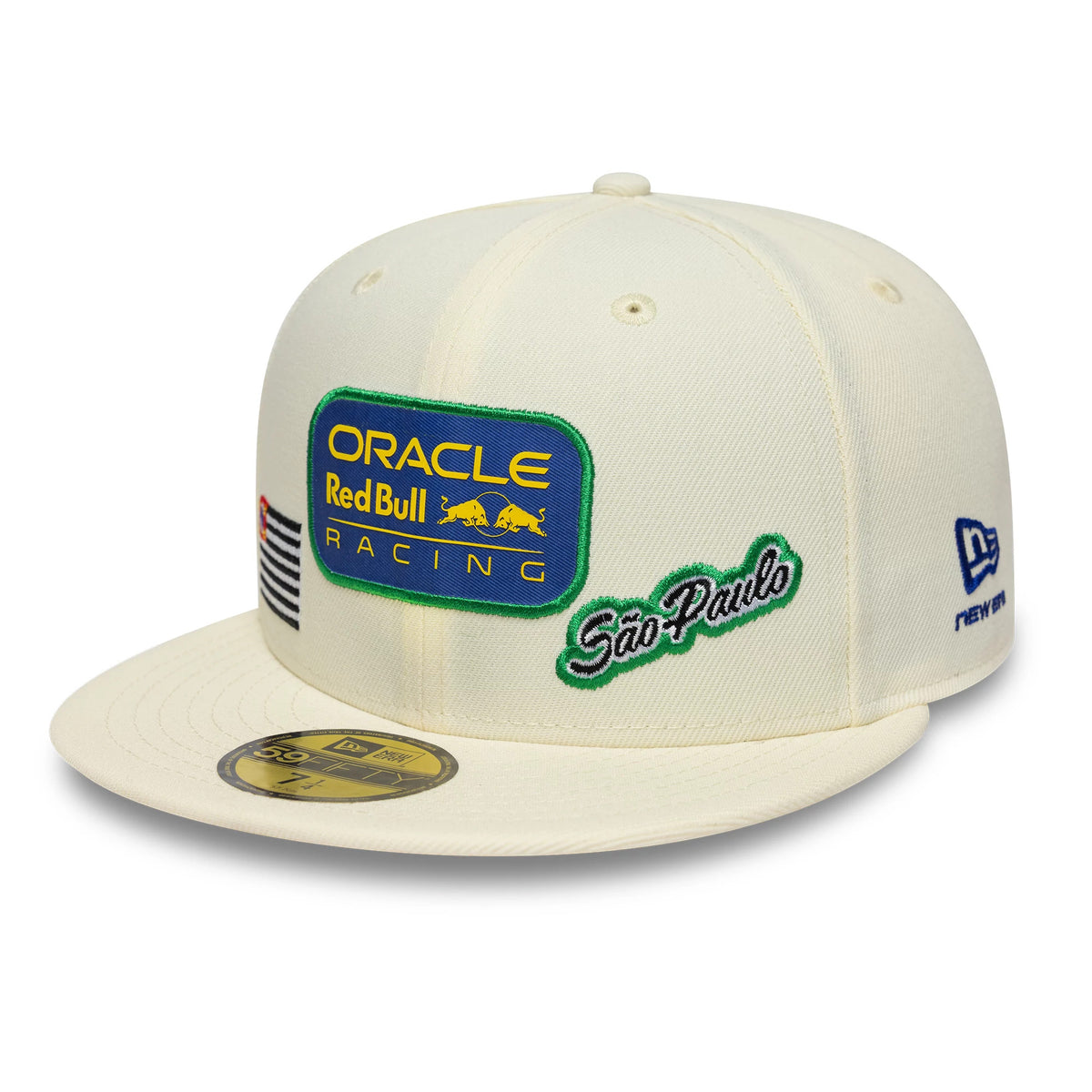 Red Bull Racing Brazil Race Special Cream New Era 59FIFTY Fitted Cap, three-quarter view showing the large embroidered Oracle Red Bull Racing patch on the front panel, Sao Paulo script on the side, and a 59FIFTY size sticker on the flat cream visor.
