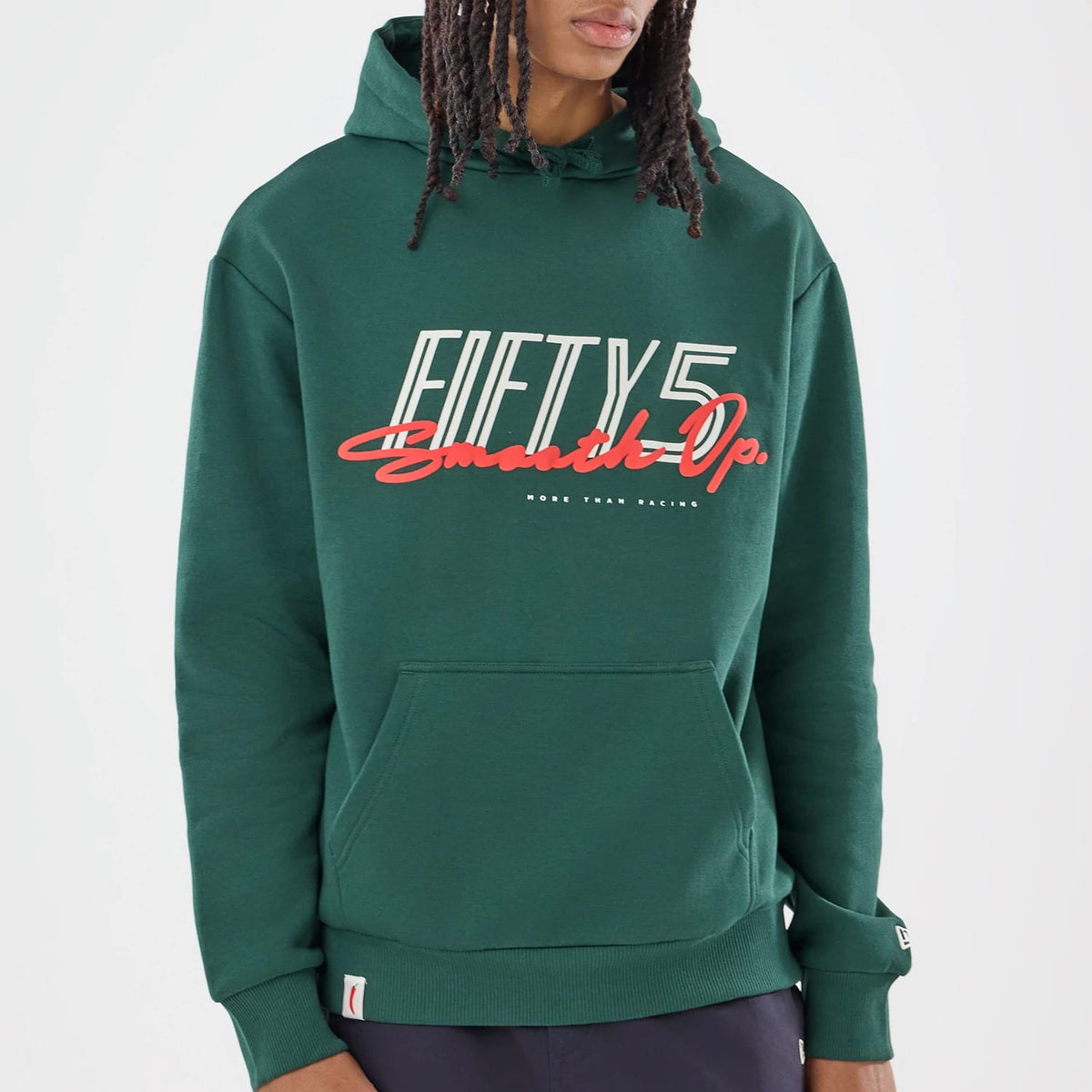 New Era Carlos Sainz Team Fifty5 Smooth Dark Green Oversized Pullover Hoodie, front view on a model showing large white and red lettering across the chest, a spacious front pocket, and an embroidered New Era logo on the left cuff.