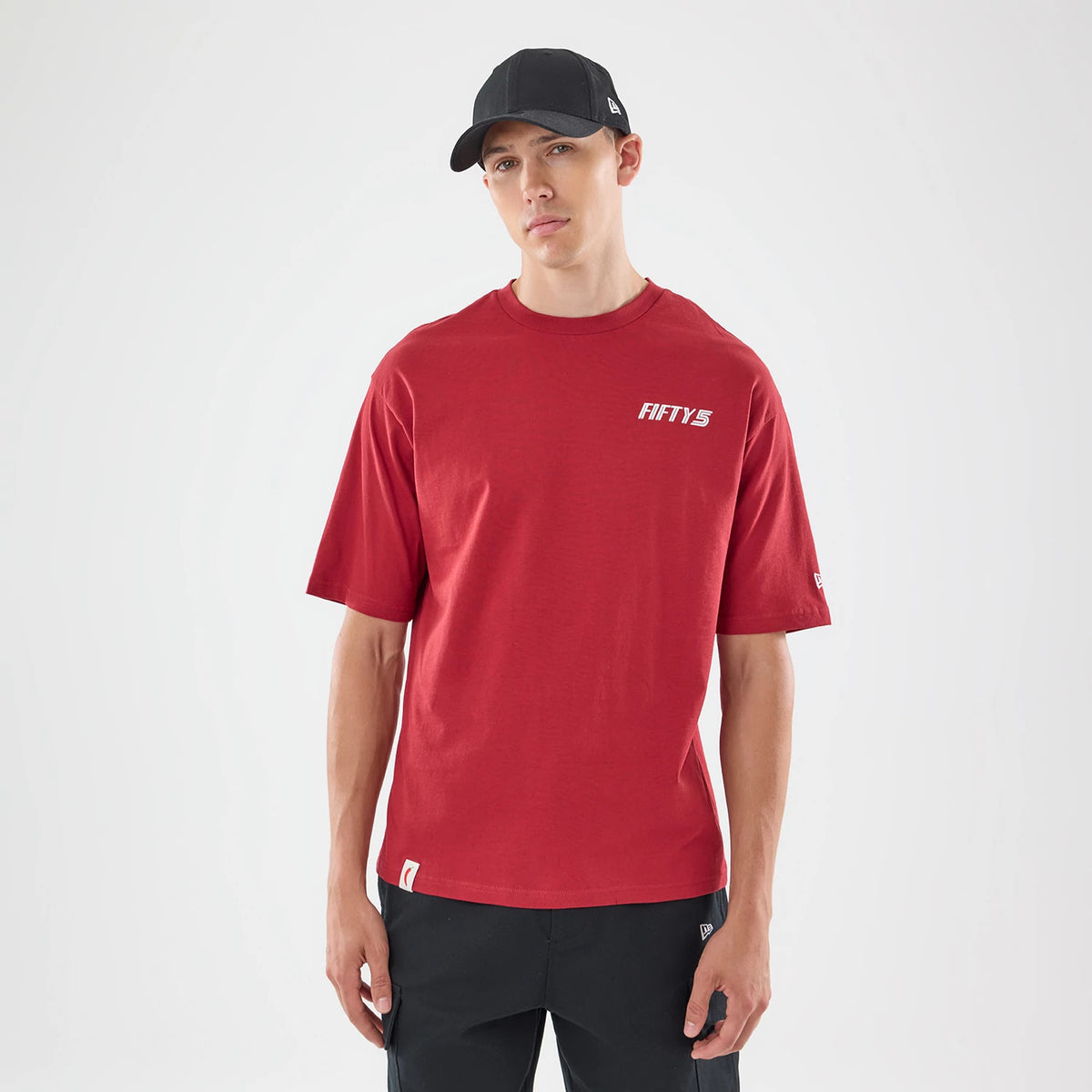 The model is wearing this Carlos Sainz Team Fifty5 Madrid Oversized T-Shirt in dark red. 1