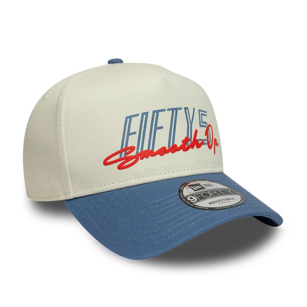 Carlos Sainz Team Fifty5 Contrast Visor Cream New Era 9FORTY A-Frame Adjustable Cap, three-quarter view showing the blue embroidered Fifty5 logo and red Operator script on the cream crown.