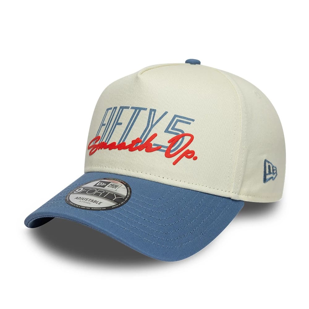 Carlos Sainz Team Fifty5 Contrast Visor Cream New Era 9FORTY A-Frame Adjustable Cap, three-quarter view showing the blue and red Fifty5 Op. embroidery on the cream front panel, a curved blue visor, and a 9FORTY size sticker on the top.