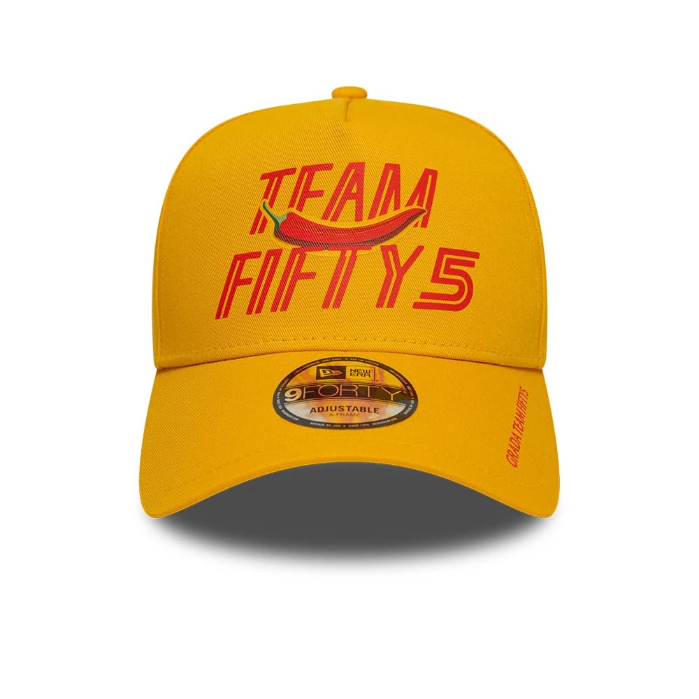 Carlos Sainz Team Fifty5 Grandstand Dark Yellow New Era 9FORTY A-Frame Adjustable Cap, front view showing the red embroidered Team Fifty5 logo with a pepper graphic on the structured dark yellow crown.