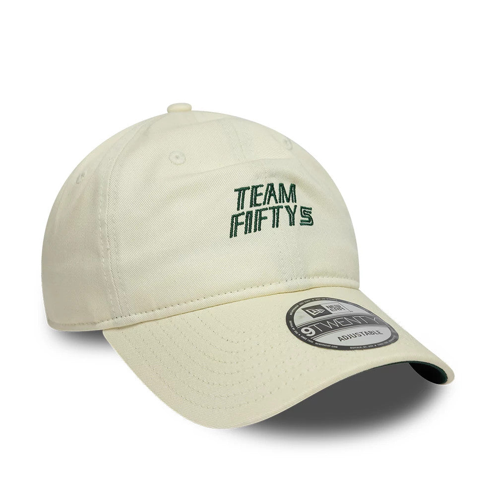 Carlos Sainz Team Fifty5 Cream New Era 9TWENTY Adjustable Cap, front view showing green embroidered Team Fifty5 logo on the cream unstructured crown, with a curved cream visor and a 9TWENTY size sticker on top.