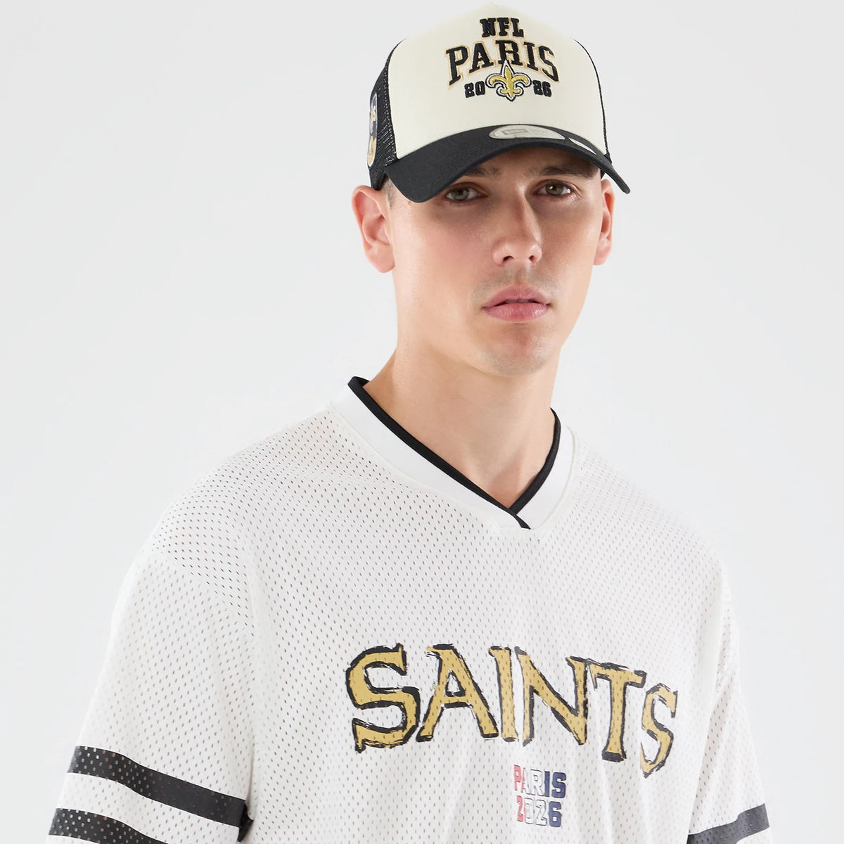 The model is wearing this NFL International Games 2026 Graphic New Orleans Saints Mesh Jersey in white. 4