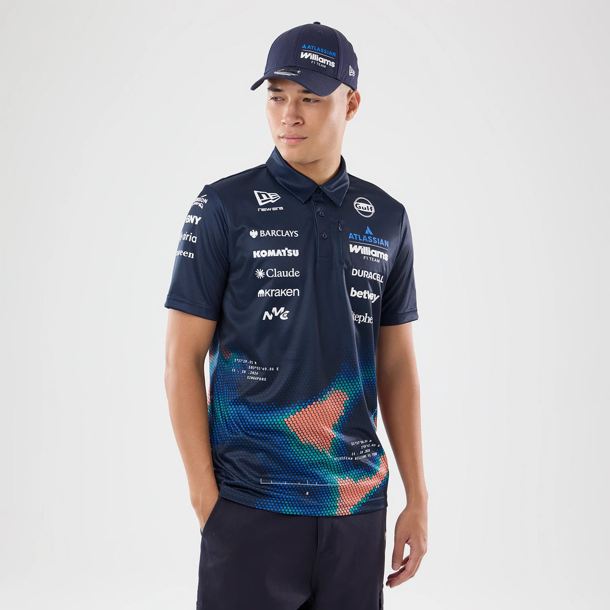 New Era Williams Singapore Navy Tech Polo T-Shirt, three-quarter view on a model paired with a New Era cap, featuring multiple sponsor logos printed on the upper front, a classic polo collar.