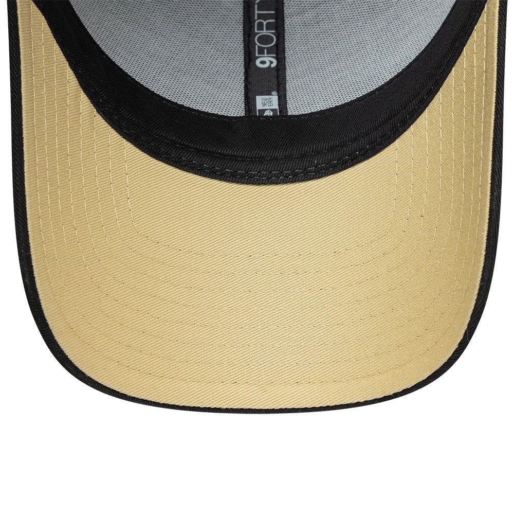 New Orleans Saints NFL International Games 2026 Paris Black New Era 9FORTY Adjustable Cap, inside view showing the contrasting gold undervisor, black headband, and interior taping with '9FORTY' text in white against a grey fabric background.