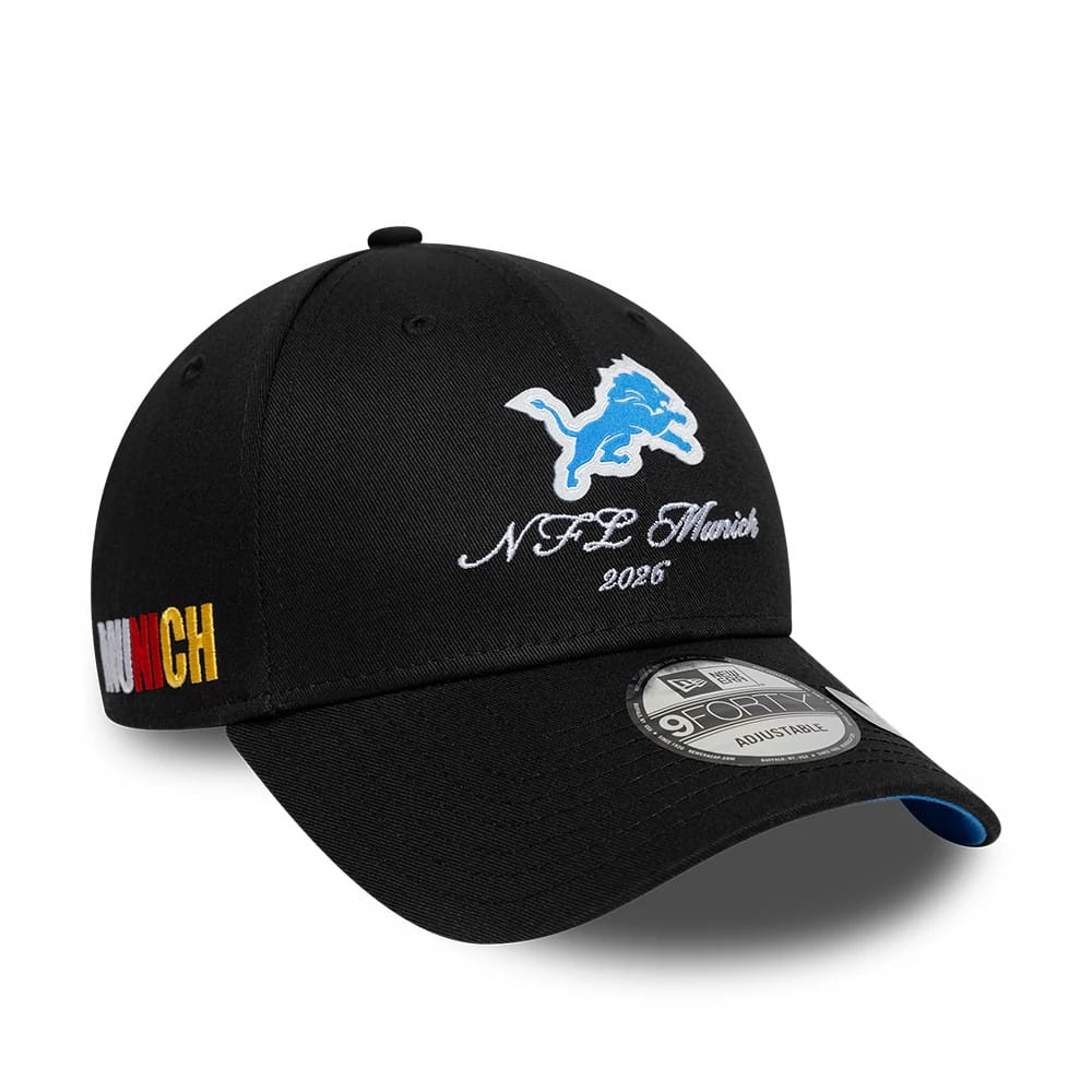 Detroit Lions NFL International Games 2026 Munich Black New Era 9FORTY Adjustable Cap, front view showing the blue embroidered Lions logo, NFL Munich 2026 script on the front panel, and a 9FORTY size sticker on the curved black visor.