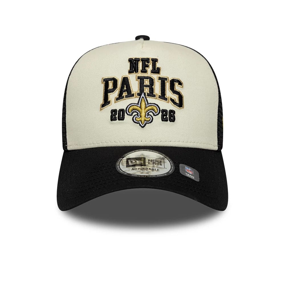 Saints NFL International Games 2026 Paris Black New Era 9FORTY A-Frame Trucker Adjustable Cap, front view showing the black and gold embroidered NFL Paris 2026 text and fleur-de-lis logo on the cream front panel, with a curved black visor.