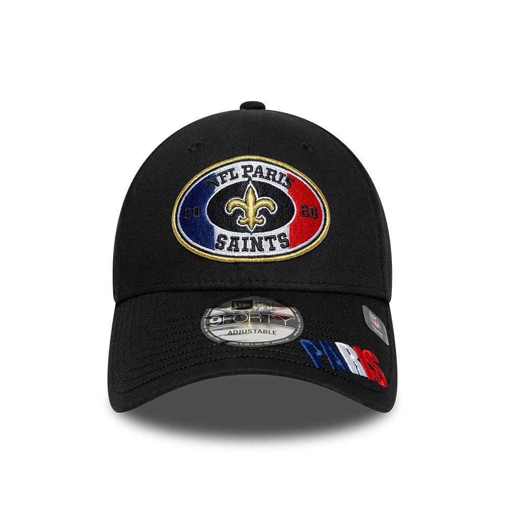 New Orleans Saints NFL International Games 2026 Paris Black New Era 9FORTY Adjustable Cap, front view showing an oval embroidered logo in gold, blue, and red with 'NFL Paris Saints' text, and a 9FORTY size sticker on the curved black visor.