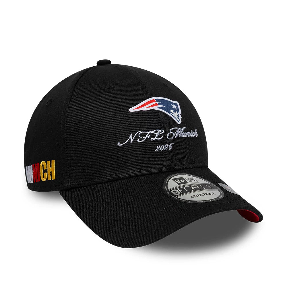 New England Patriots NFL International Games 2026 Munich Black New Era 9FORTY Adjustable Cap, three-quarter view showing the raised embroidered Patriots logo above NFL Munich 2026 on the front panel, gold MUNICH on the side.
