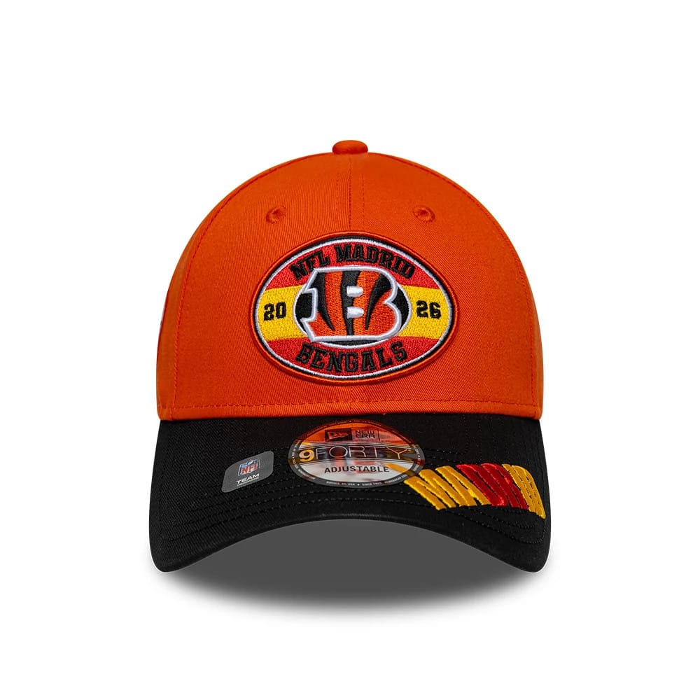 Bengals NFL International Games 2026 Madrid Orange & Black New Era 9FORTY Adjustable Cap, front view showing a Bengals logo embroidered within a yellow and red oval patch on the orange crown, with a black visor featuring a 9FORTY size sticker.