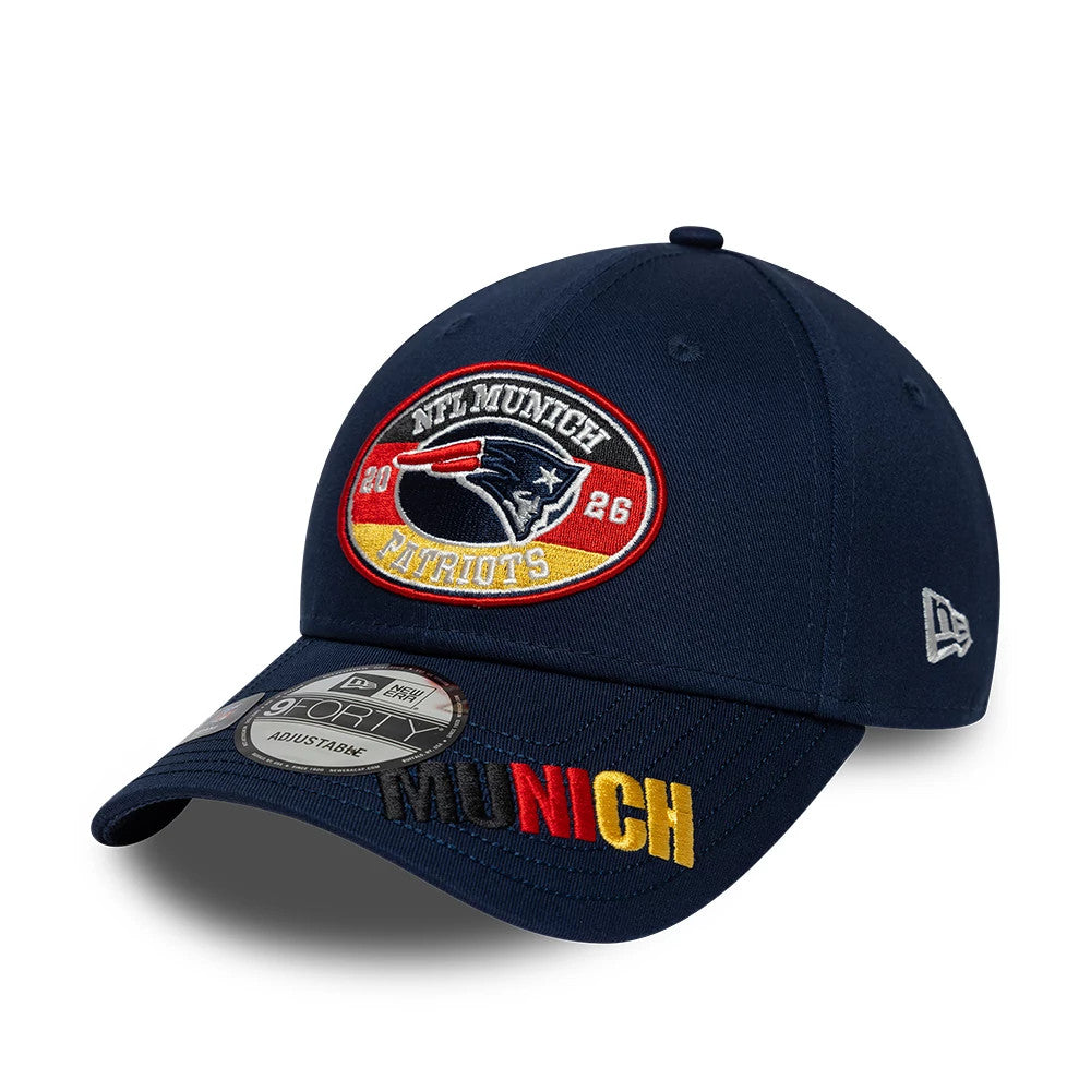 New England Patriots NFL International Games 2026 Munich Dark Blue New Era 9FORTY Adjustable Cap, front view showing the embroidered logo patch with Patriots imagery and text on the front panels, curved visor with Munich stitching.